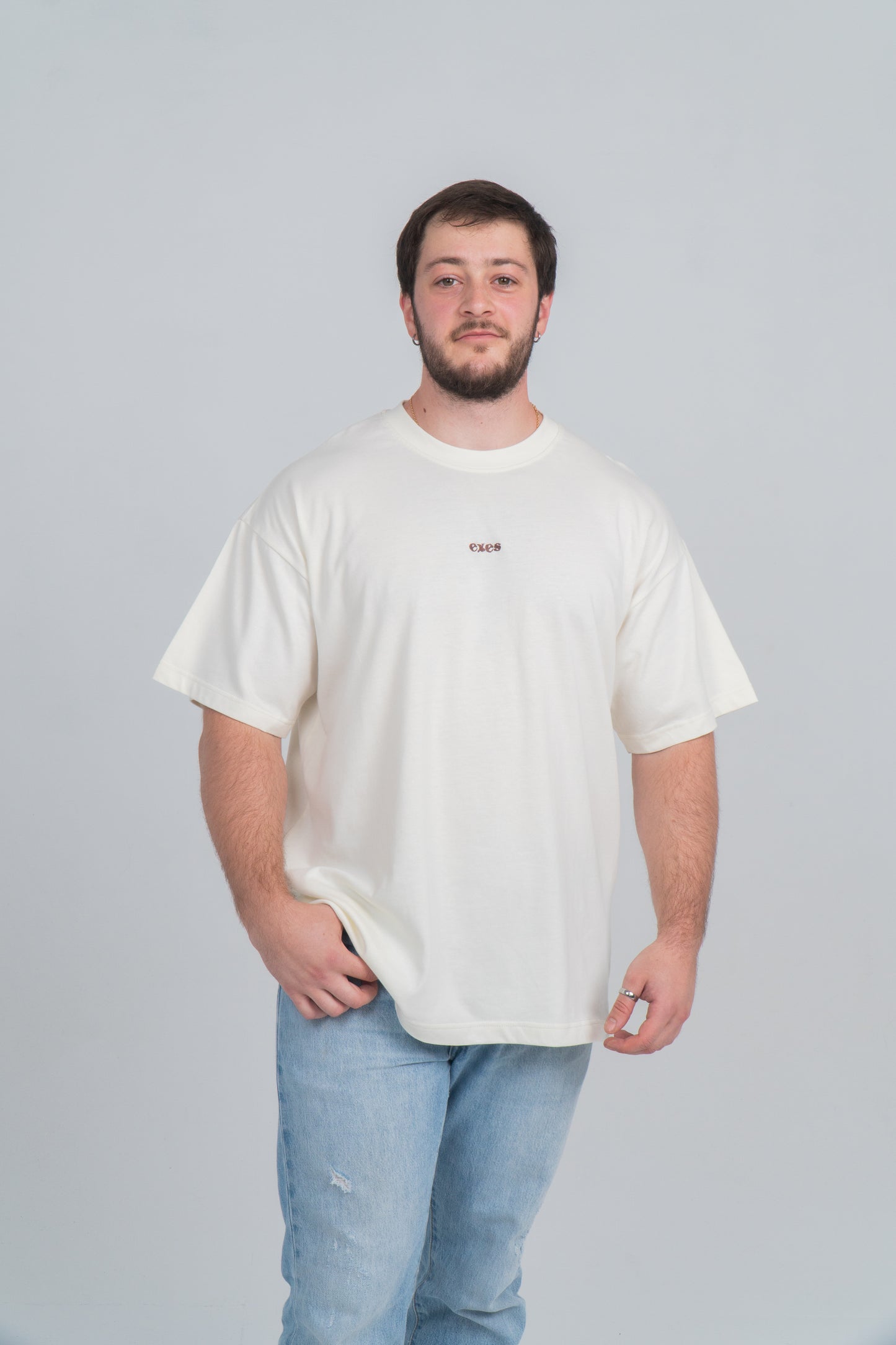 Chico llevango camiseta/tee beige con el logo de exes bordado en el pecho.